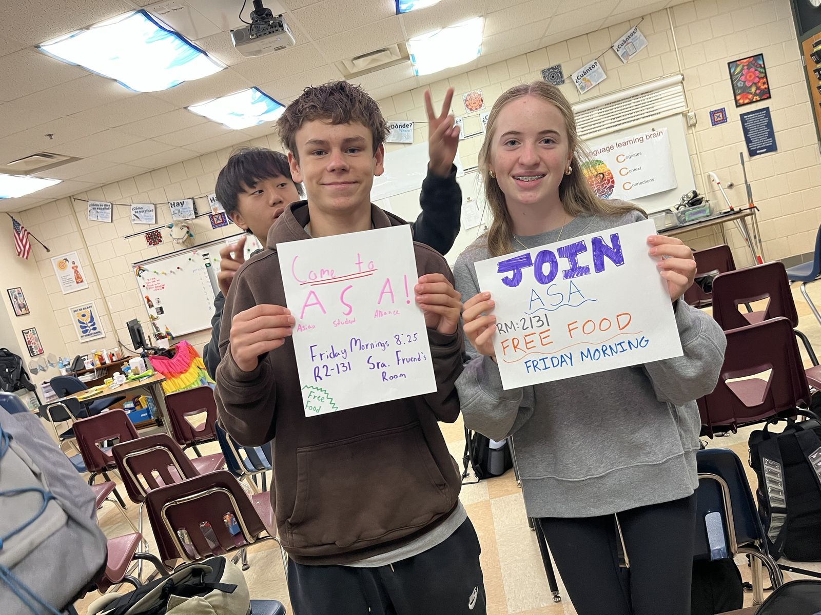 Two students holding up hand-drawn "Come to ASA" and "Join ASA" posters